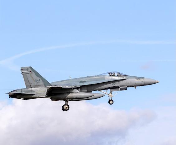 A government of canada, national defence fighter jet in the colour gray with the Canadian flag on the tail of the jet