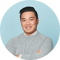 Business man wearing a gray sweater smiling