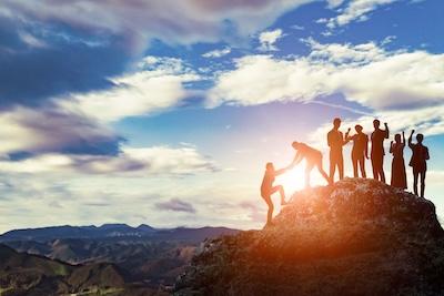 Image of a group successfully hiking a mountain and looking onwards